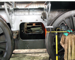 The area previously occupied by the trailing sandbox, whose removal has allowed further cleaning and an application of primer paint.