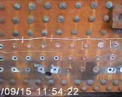 Close up of the drilled stays and burned through rivets in the lower right hand side.