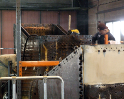 A view towards the boiler with full-time staff at work.