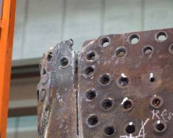 Corner between the backplate (left) and firebox sides, showing how the former is being cut to release it.