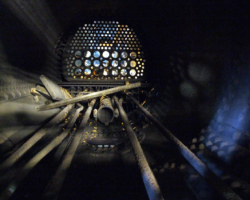 Inside the boiler from the front end. All tubes have long been removed, but longitudinal stays and part of the main steam pipe remain, shown at the bottom of the photo.