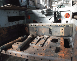 The arrow shows the rear frame stretcher which is part of the platework that will be renewed.