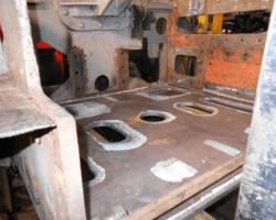 A view of the new base plate sitting on the forklift truck being offered up to the strips prior to tack welding.