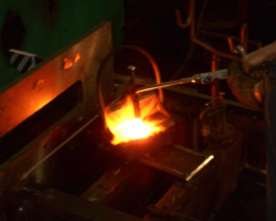 Heating a new rivet prior to fitting it.