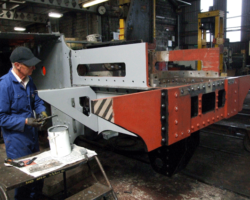 SMF working member hard at work with paintbrush in hand.