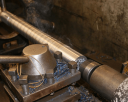 Two shots of one valve spindle in the lathe having the initial turning done.