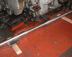 On the floor the first valve spindle awaits final turning to size.