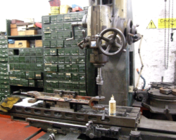 In the machine shop, one of the cross ties from one side horn guide to the other is having the pin holes milled out to accept new pins.
