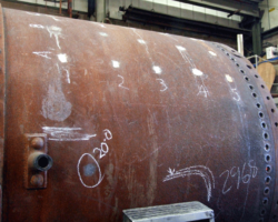 The metal thickness of the front barrel ring is also to be measured ultrasonically. What appear here to be white patches are actually bare metal where the surface rust has been ground away for the tests to be made.