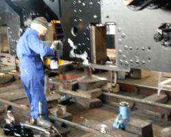 The painters at work again, this time eliminating the grey primer from the frames and returning them to a proper black!