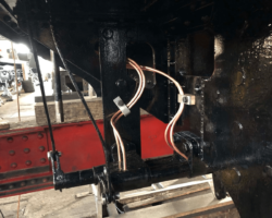 The most recent of our work on new lubrication pipes can be seen here under the Right hand side of the cab ready to feed oil to the firebox damper mechanism relay. The long spindle with the square end in the background is the Right hand or fireman’s side injector water valve spindle.