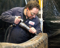 The weld is then chiselled flat, the task seen here being carried out by SVR full-time staff.