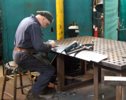 Brian at work fabricating the left hand fall plate and hinges.