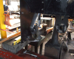 The view forward from behind the buffer beam. The injector body is to the left behind the cab step; right is the bracket to carry the connection from the tender, the flange of the water regulator valve just visible in front of it.