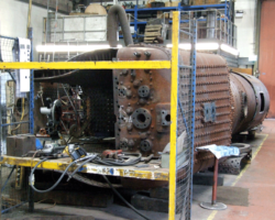 In the boiler shop, the boiler has been rotated 180 degrees and now rests on its right hand side to allow the same work previously done to the other side to be repeated.