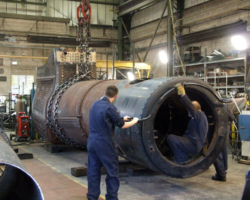Progress in the boiler shop means that the work on the rear of the copper side and roof plates is finished and the boiler was this day turned so it is again inverted. Work to fit the reconditioned inner firebox backplate will now begin, followed by the fitting of the new lower outer backplate.
