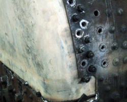 Parts of the original side sheets have been cut away to allow access for the boilersmith to weld the new and old sections together behind the normal rear end of the sides.