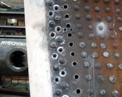 Attaching it to the foundation ring and firebox side sheets.