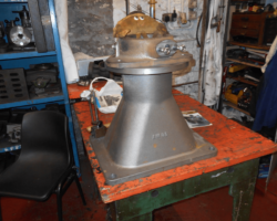 The new blast pipe with the blower ring sitting on top - both are being supervised by Patrick the machine shop mascot.