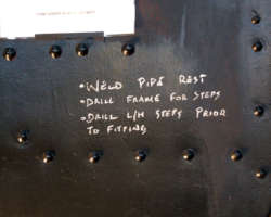 Work on the frames continues, with a small list of jobs chalked on the cabside.