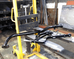 Freshly painted parts, comprising a length of piping for the right hand feed water system, and parts of the firedoor operating mechanism.