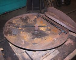 Meanwhile, elsewhere in the shed is the smokebox door showing the handrail after removal.