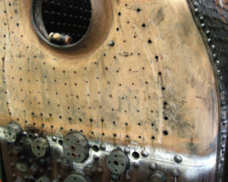 Close up of the backplate with many holes drilled and others marked out.