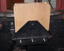 This seat automatically stays in the upright postion so does not need a bolt to holt it in place. The surplus thread on the bolts will be cut off when the seat is permanently fitted in place.
