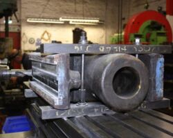 whilst the second one is mounted on a milling machine having the same work done to it - the marked out guidelines can clearly be seen on the end facing the camera.