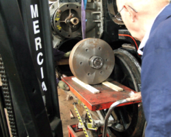 The piston rod inserted and sitting on wooden packing inside the cylinder. It is important to remove this once the rod has entered the back cover but before the piston head has blocked off the front end.