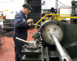 Here Graham used a dial test indicator (d.t.i.) gauge, centre, to check that the piston head would run true, slackening and tightening alternate jaws until all run-out was eliminated.