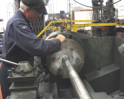 With the grooves completed, Graham begins the delicate task of fitting the rings. Now it is known that clearances within the cylinders are good, the pistons will be refitted to them with the rings already in place.