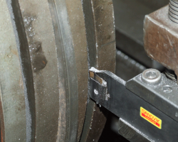 A close up of the cutting tool in the groove.