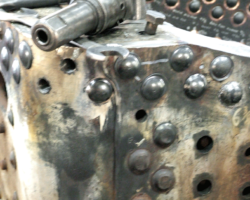 A close up view of area, with a pneumatic hammer resting on top.