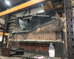 In the boiler shop a few days earlier, the ashpan had been trial fitted to make sure it sits properly against the foundation ring. A minor discrepancy was being corrected on 10 February.