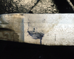 The original scribe mark against engineers’ blue with the pop marks shown.