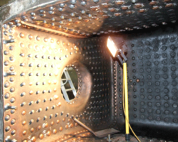 A wider view inside the firebox. The protruding studs are supports for the grate.