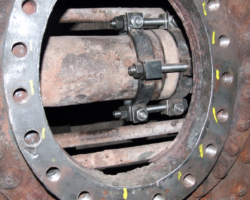 ...to which it is clamped by this rather complex arrangement comprising four studs and nuts, which the boilersmiths were in the act of tightening. The three seen are easy of access, but the fourth is on the far, lower, side of the pipe.