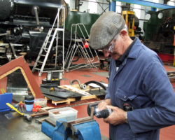 All four windows can be slid open on small brass corner pieces. New ones have been cast and are being drilled for fitment to the frame in the background, which has been rebated to accept it.