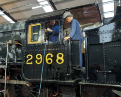 Having fitted the front spectacle plate, the working party tackled the first of
the side windows.