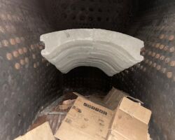 The inside of the firebox with the recently installed rocking grate and brick arch (in grey).